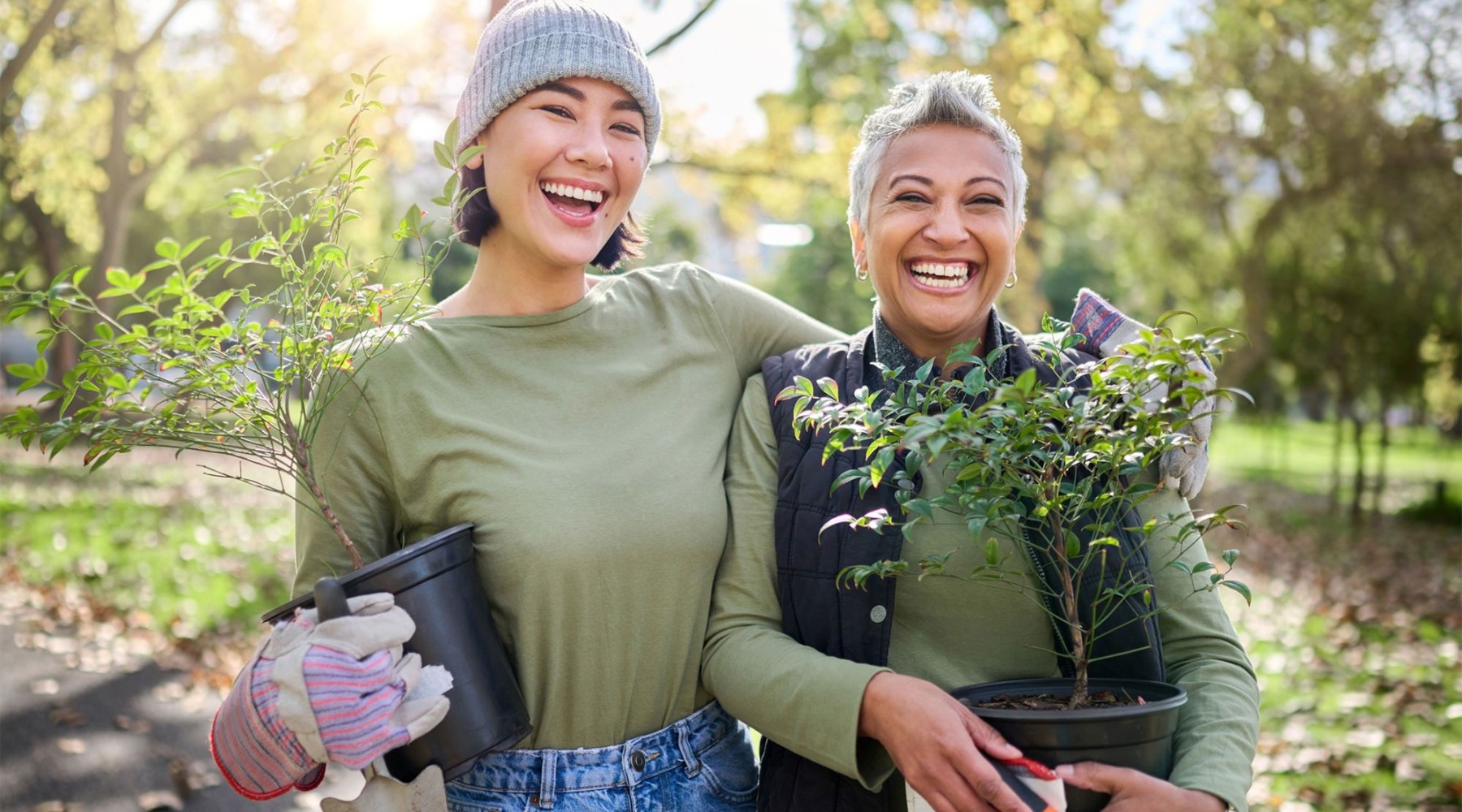 a couple of women holding plants
