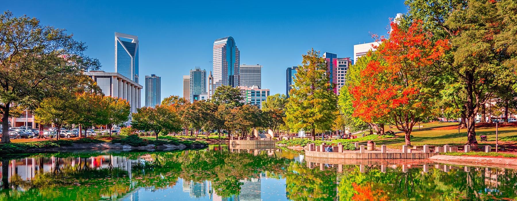 a body of water with trees and buildings in the background