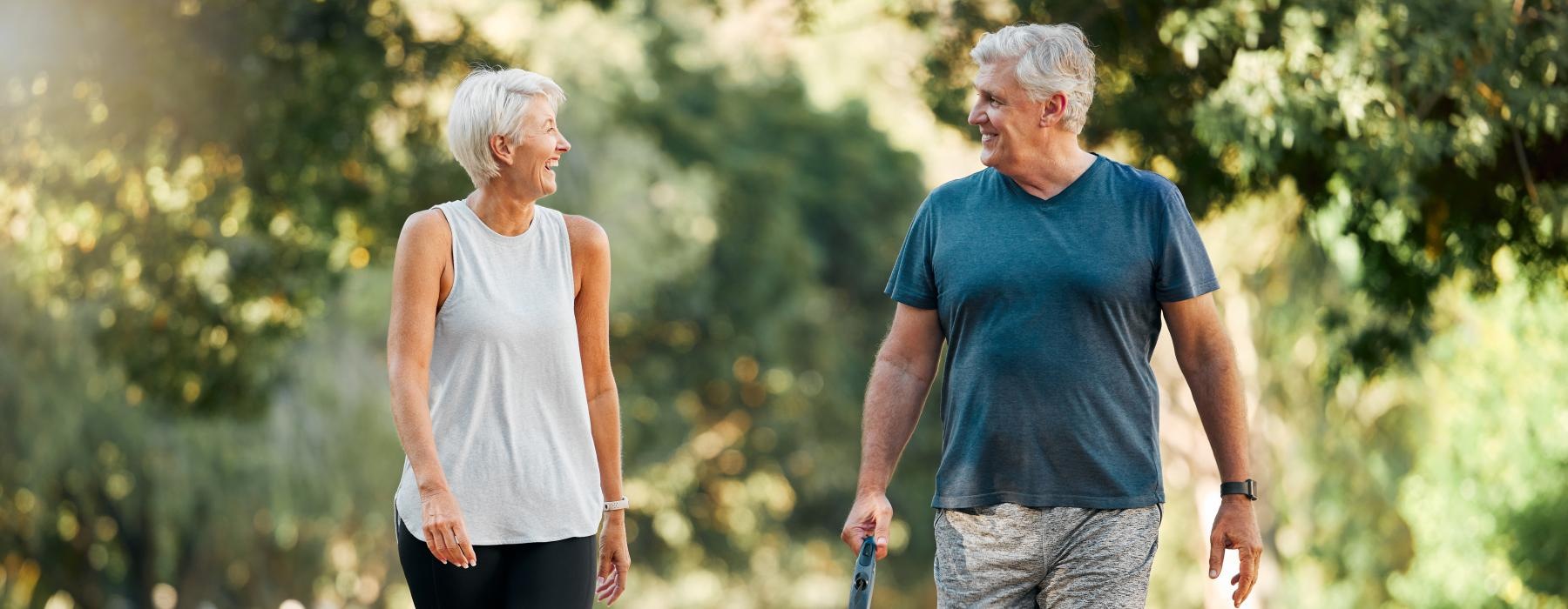 a man and woman walking a dog