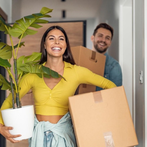 a woman holding a box and a man holding a box