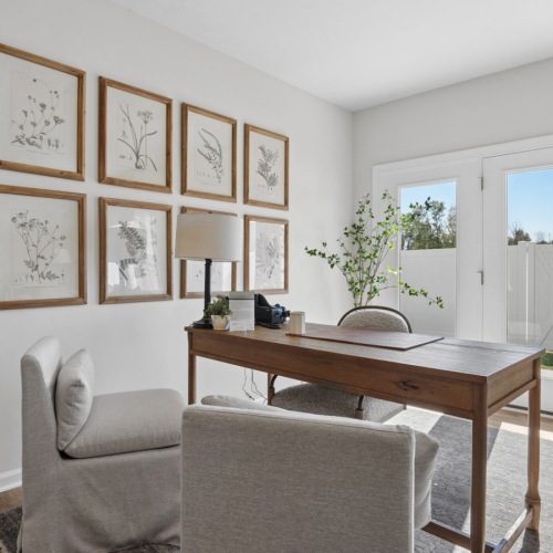 desk in room with large windows